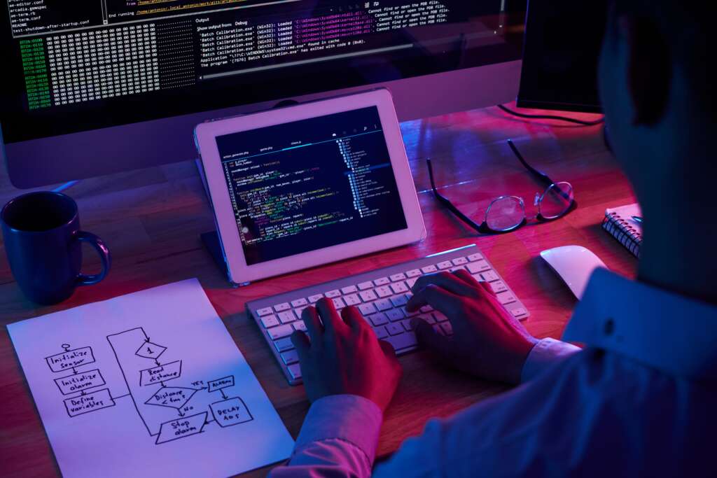 DevOps professional programmer working late dark office